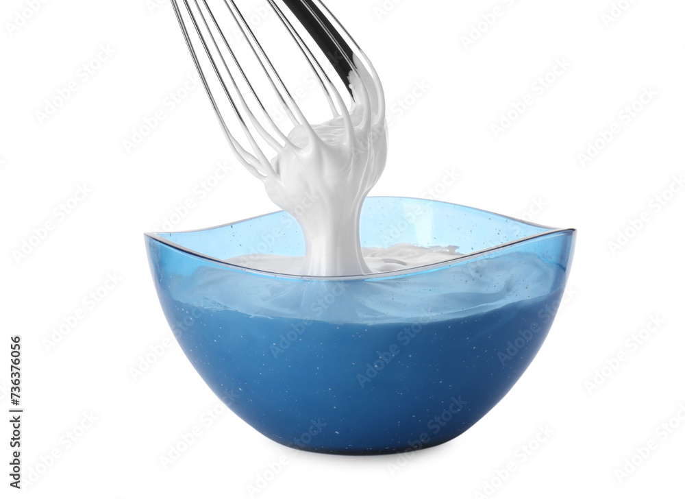 Whipped cream flowing from whisk into bowl isolated on white Whipped cream flowing from whisk into bowl isolated on white