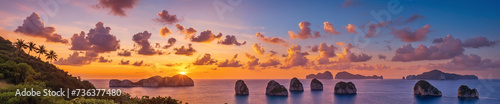 Tranquil ocean sunset with majestic rock formations and serene cloudy sky