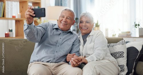Senior couple, selfie and sofa with love, social media and happy together in a home. Retirement, marriage and profile picture with elderly people in a house on a website online with support and trust © Wesley/peopleimages.com