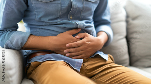 Gastroenterologist examining patient with stomach pain on couch in clinic  closeup