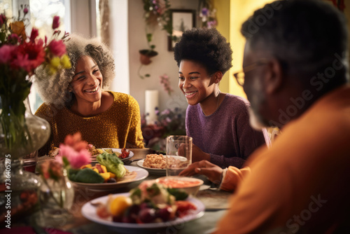 Afro-American family grandfather  grandchildren having breakfast lunch together. Spring time  easter  cosy kitchen dinning room. Happy together festive Sunday  cheerful atmosphere Copy space design