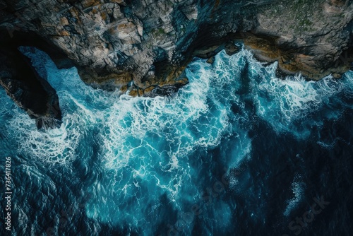Aerial View of the Deep Blue Ocean With Waves Crashing Against Rocky Shoreline  Awe-inspiring aerial portrait of a rippling sea against a rocky headland  AI Generated