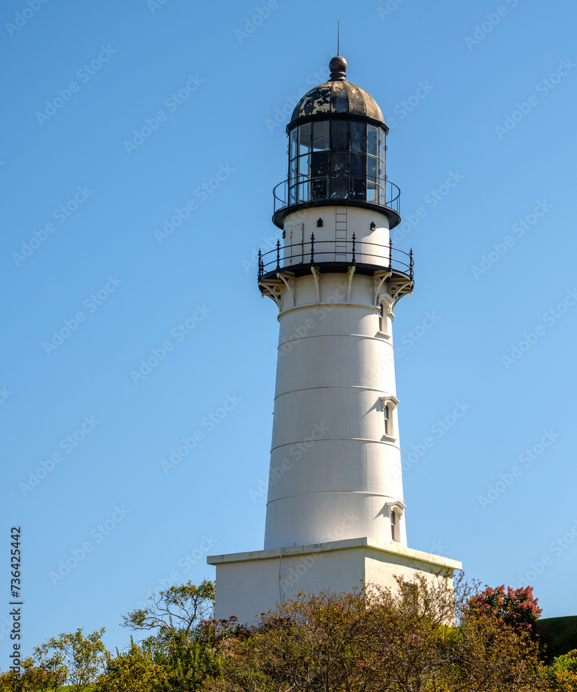 Low angle view of a New England Lighthouse against a  clear blue skyNew England