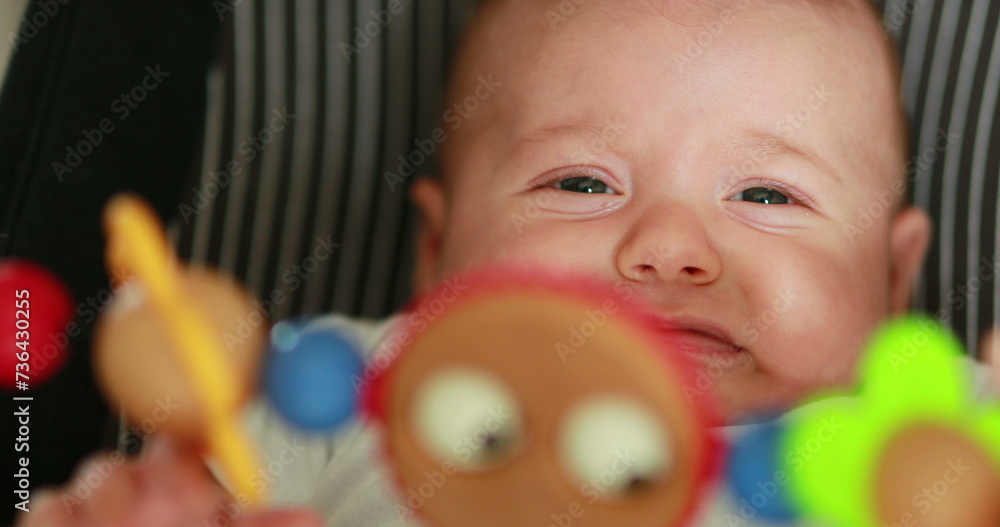 Toy spinning with baby infant in background Toy spinning with baby infant in background