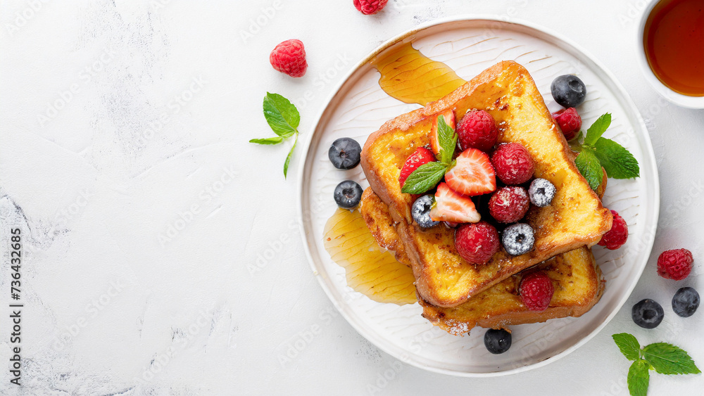 French toast with fresh berries and syrup on white background, panoramic shot with copy space