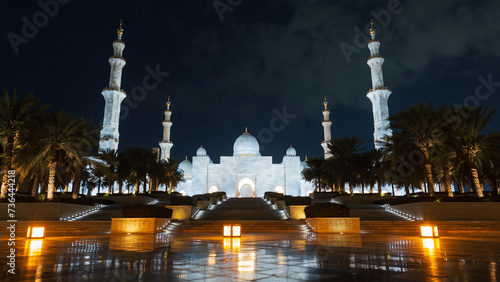 Amazing beautiful mosque with palm trees and lights in the night city of Abu Dhabi. Sheikh Zayed Grand Mosque in the dark