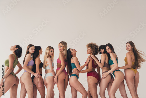 No filter studio photo of dreamy pretty women wear underwear enjoying girls power isolated beige color wall background photo