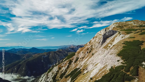 Panoramic view of majestic mountain peak Karlhochkogel in untamed Hochschwab mountain region, Styria, Austria. Scenic hiking trail on sunny day in remote Austrian Alps. Wanderlust in alpine spring © Chris