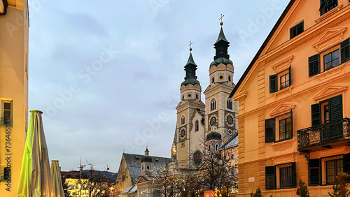 Cathedral of Santa Maria Assunta in Bressanone, Brixen, Italy. Twilight. The square in front of the cathedral is decorated with Christmas decorations and lights. Mobile photo