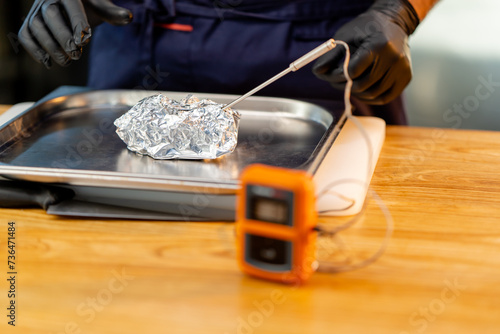 Schilderij op canvas close-up of an orange device measuring the temperature of food stands on light t