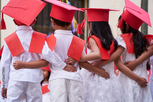 Latin pre primary children students embracing together after their graduation to get into elementary school 