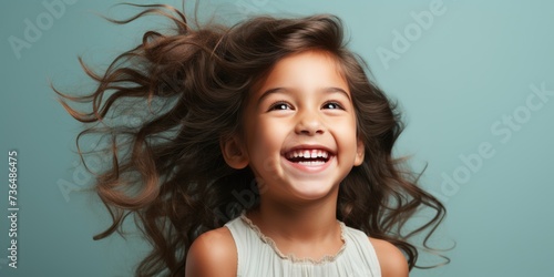 a little girl with her hair blowing in the wind,  happy girl, smiling girl, happy kid