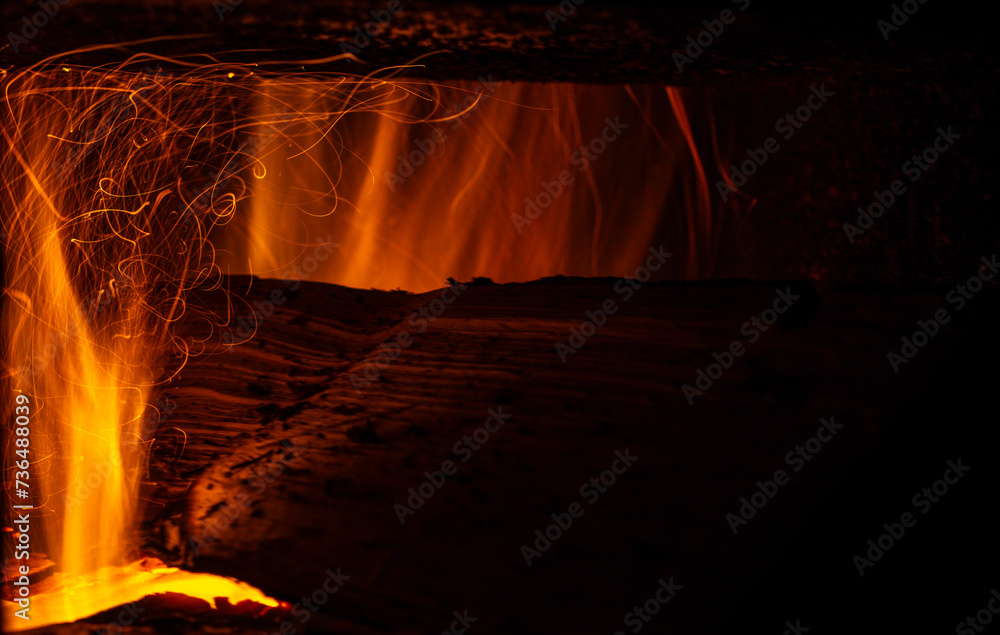 Flame from burning logs in a stove