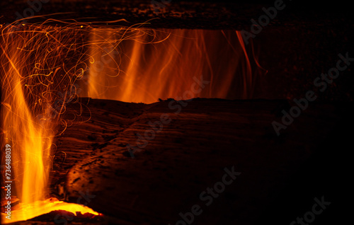Flame from burning logs in a stove