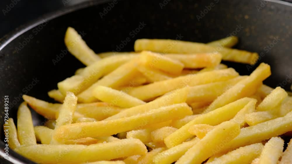 Stirring fried potatoes in a frying pan, close-up. Cooking potatoes. Stirring fried potatoes in a frying pan, close-up. Cooking potatoes.