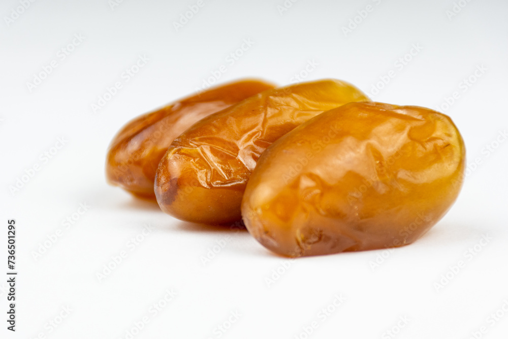 Close-up of dates against a white background. Ramadan concept. Close-up of dates against a white background. Ramadan concept.