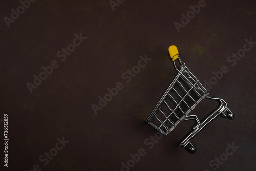 Grocery cart on a brown background.