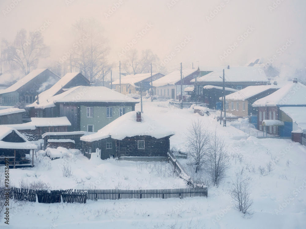 Ancient wooden huts under the snow.