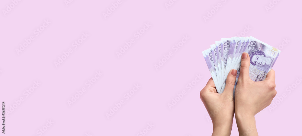 Female hands holding money on lilac background with space for text - obrazy, fototapety, plakaty 