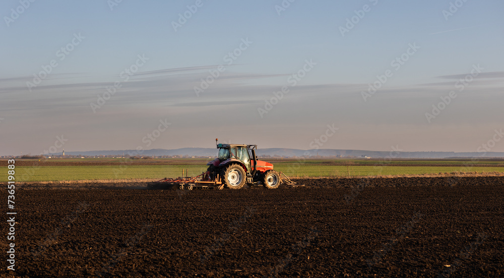 Obraz premium Farmer preparing his field in a tractor