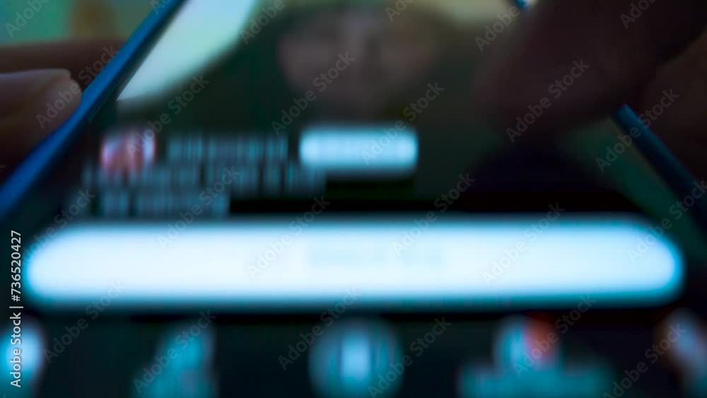 Finger scrolling through a social media feed on a smartphone screen from a low-angle, extreme close-up perspective.