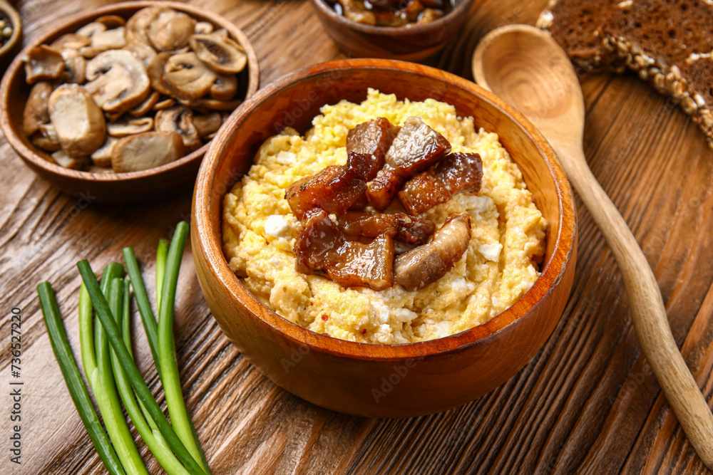 Bowl of tasty banosh on wooden background Bowl of tasty banosh on wooden background