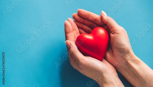 red heart in hands on a blue background 1