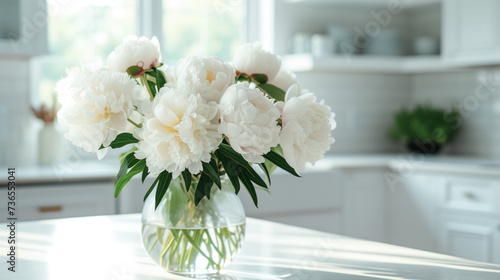 Elegant Bouquet of White Peonies in a Clear Vase on a Bright Kitchen Table.