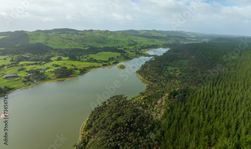 Aerial: Farlmland,lake and forestry on the west coast. Helensville, Auckland, new Zealand. photo