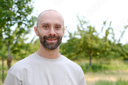 Wall Mural young 30-year-old serious man Outdoors in nature, Subtle Smile on Lips, Psycholo