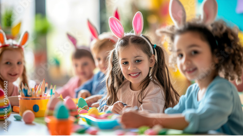 cute kids in bunny ears painting Easter eggs at home or kindergarten. children prepare for Easter