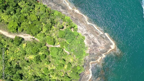 aerial drone view of the tropical beach, coastal with waves, trees, stones