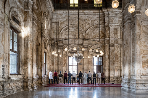 Cairo, Egypt - October 25, 2022. Group of prayers inside the Mosque of Muhammad Ali in the Citadel of Cairo. photo