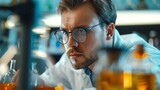 A concentrated male scientist examines a chemical solution in a flask within a high-tech laboratory setting