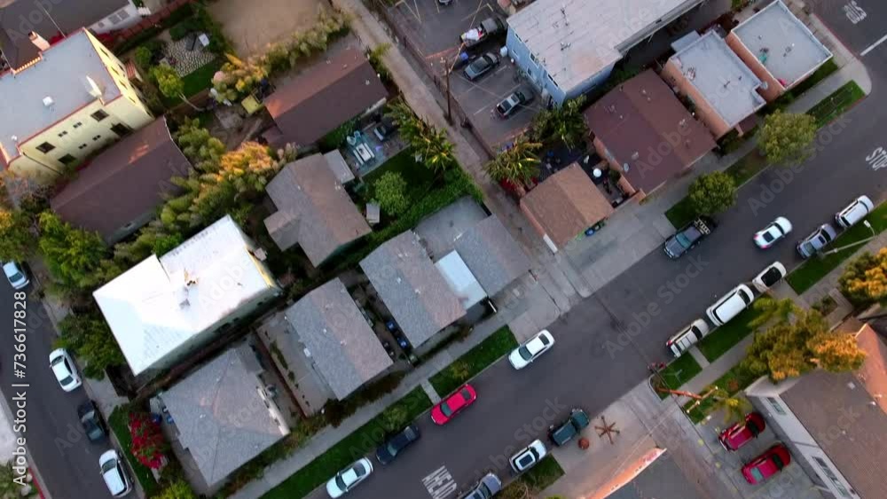 Aerial Tilt Up Shot Of Cars Parked On Roads Amidst Houses In City During Sunset - Los Angeles, California Aerial Tilt Up Shot Of Cars Parked On Roads Amidst Houses In City During Sunset - Los Angeles, California