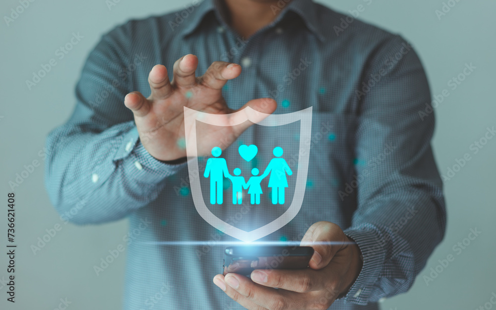 Concept of family life insurance and children health care, safety. Assurance family health saving finance. Happy life and family. Business people hand the shield insurance protected by an agent.