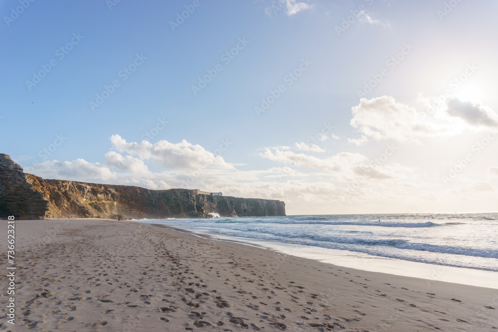 Cliff at the atlantic coast near Praia do Tonel beach with Fortaleza de Sagres in background, Sagres, Algarve, Portugal