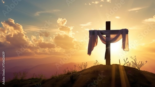 A cross with a cloth draped over it on a hill. White cloth hung on Cross crucifix, Easter background © Friedbert