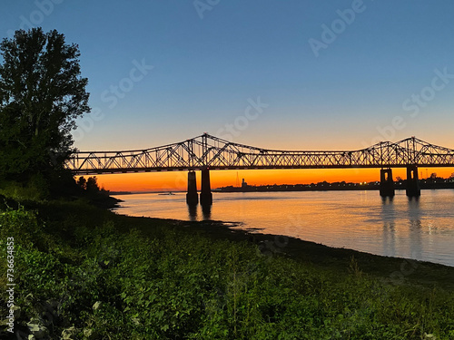 Sunset on the Mississippi River in Natchez, Mississippi with the Natchez Vidalia Bridge.