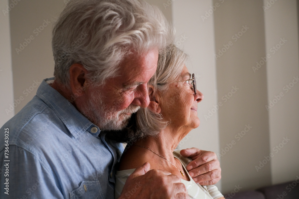 One senior man hug senior lady from behind to love and protect. Elderly lifestyle life together people. Retired couple at home thinking. Romantic sene with male and female having care each other One senior man hug senior lady from behind to love and protect. Elderly lifestyle life together people. Retired couple at home thinking. Romantic sene with male and female having care each other