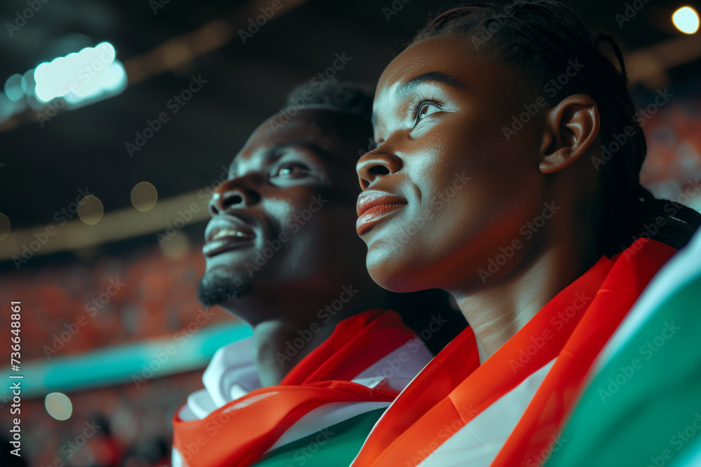 Kenya fans cheering on their team from the stands of sports stadium. Kenya fans cheering on their team from the stands of sports stadium.