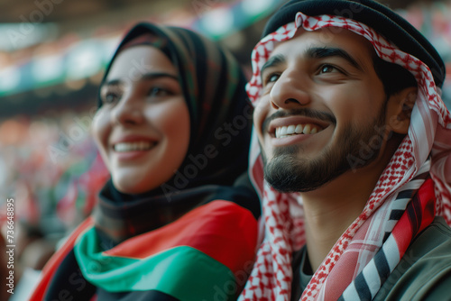 Kuwait fans cheering on their team from the stands of sports stadium.