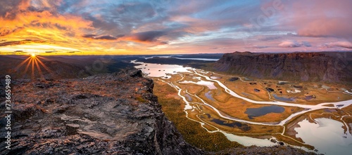View from Skierffe mountain over the autumnal Rapadalen river delta, sunrise, Rapaaelv river, Sarek National Park, Laponia, Lapland, Sweden, Europe photo