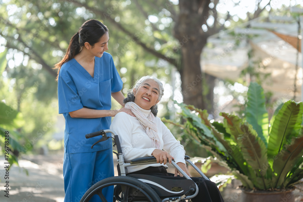 Compassionate Asian woman provides care to elderly person in wheelchair outdoors. Engaging in physical therapy, happiness, encouraging positive environment for mature individuals with grey hair. Compassionate Asian woman provides care to elderly person in wheelchair outdoors. Engaging in physical therapy, happiness, encouraging positive environment for mature individuals with grey hair.