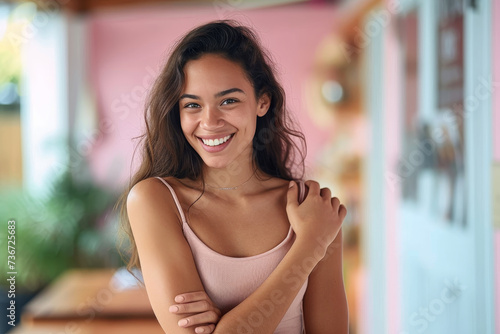Wallpaper Mural A cheerful young woman with a beaming smile looking at the camera in a brightly colored indoor setting Torontodigital.ca