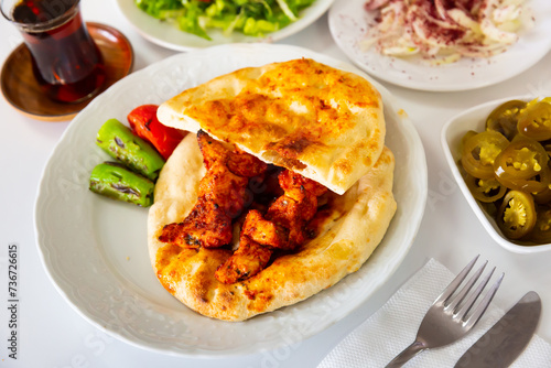 Traditional chicken kebab, tortillas and stewed vegetables. Turkish cuisine © JackF
