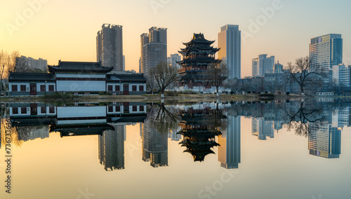 Ziyang Lake Park (locate in Wuhan, Hubei province, China) at sunset and its reflection on the calm lake.