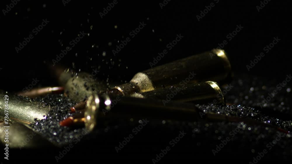Detail macro shot of bullet falling on pile of gunpowder, tilt down, close up