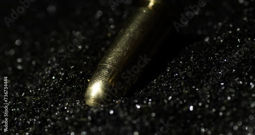 Smokeless Powder With A Pair Of 9mm Parabellum Bullets. Slow Motion, Close Up photo