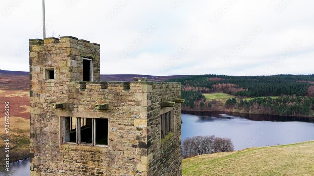 Old derelict castle, monument, disused stone tower, with people walking around and flying a drone. English countryside Old derelict castle, monument, disused stone tower, with people walking around and flying a drone. English countryside
